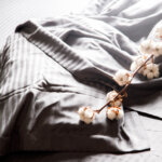 Bedding is gray. Soft natural fabric is cotton, satin, linen.