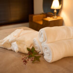 Gowns and towels on the bed in the beauty salon